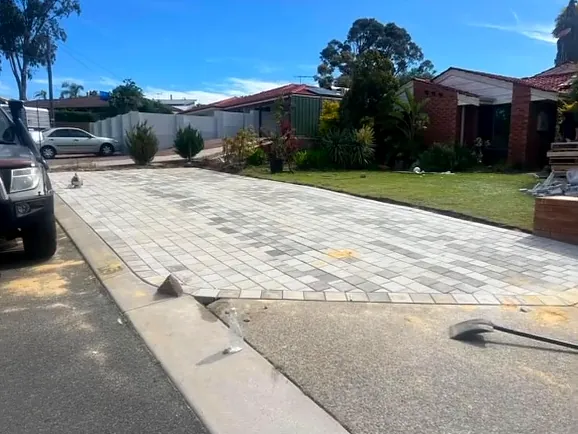 Grey paved driveway with a contrasting border