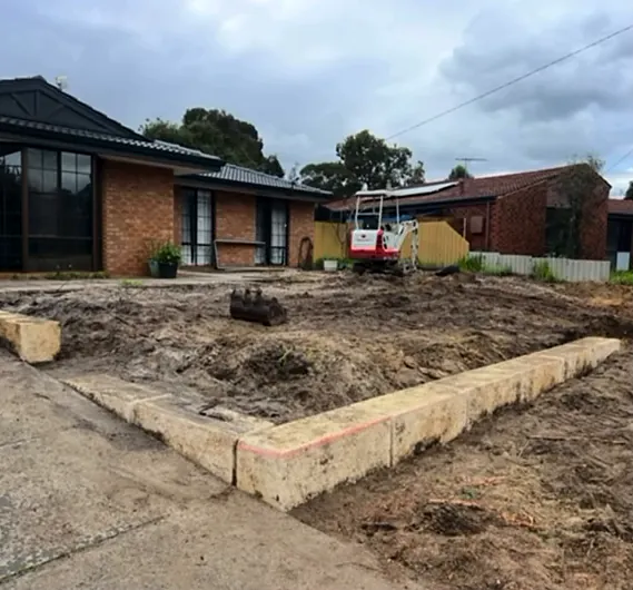 Front yard with the first course of limestone blocks laid along the boundary